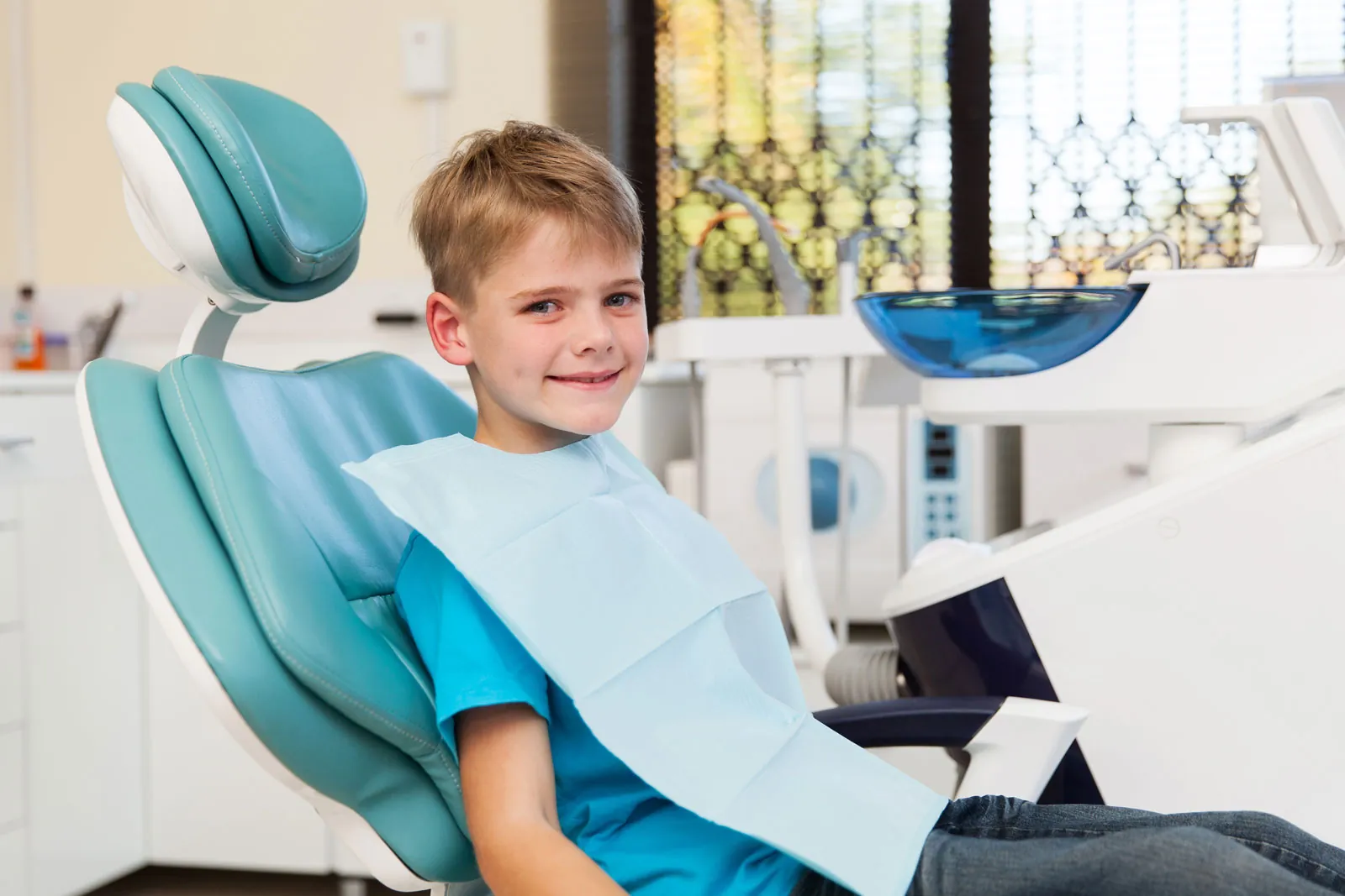 A young boy smiling in the treatment chair at Sytek Orthodontics