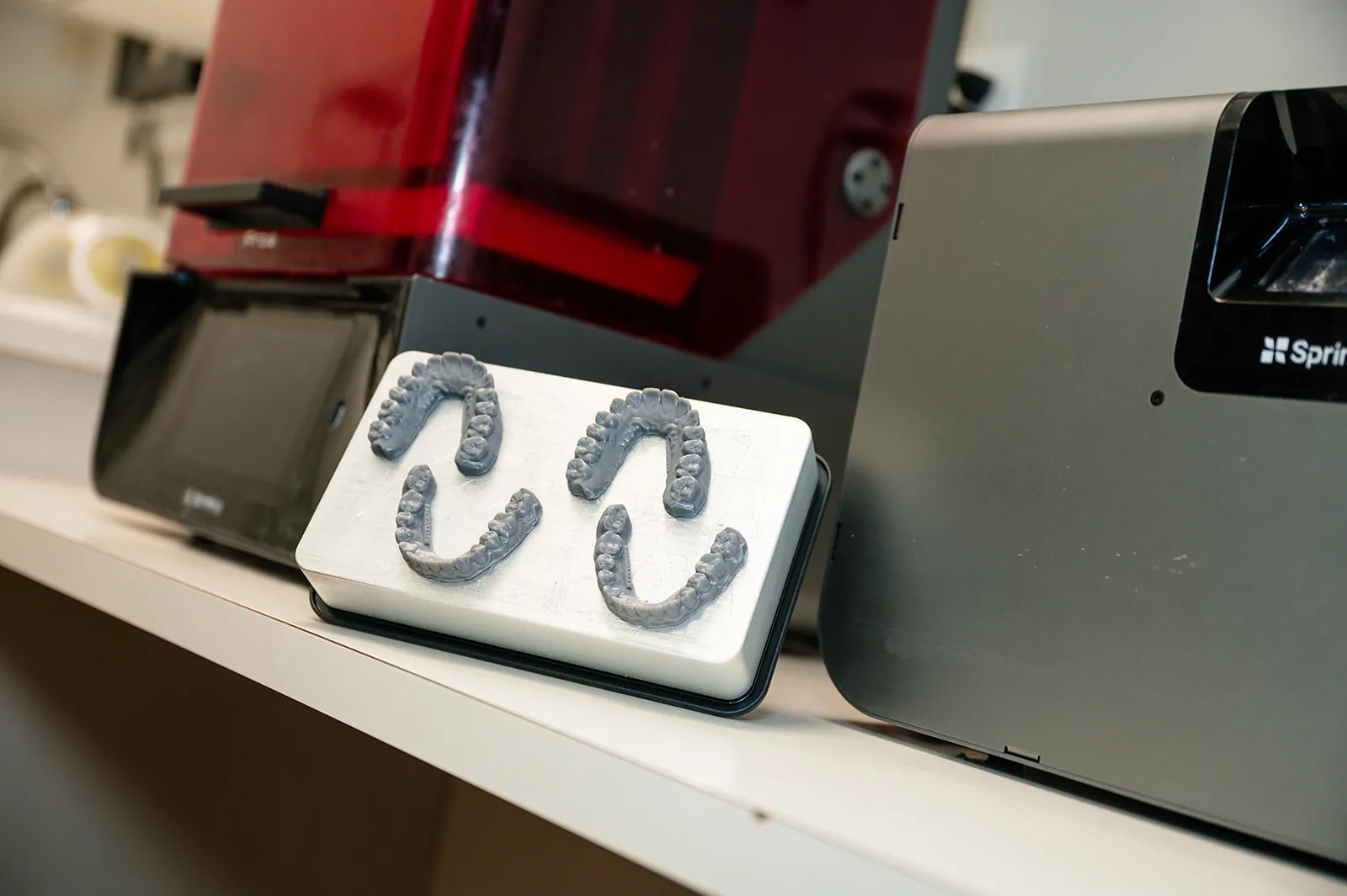 Clear aligner models 3D printed in-house at Sytek Ortho, on the printer build plate